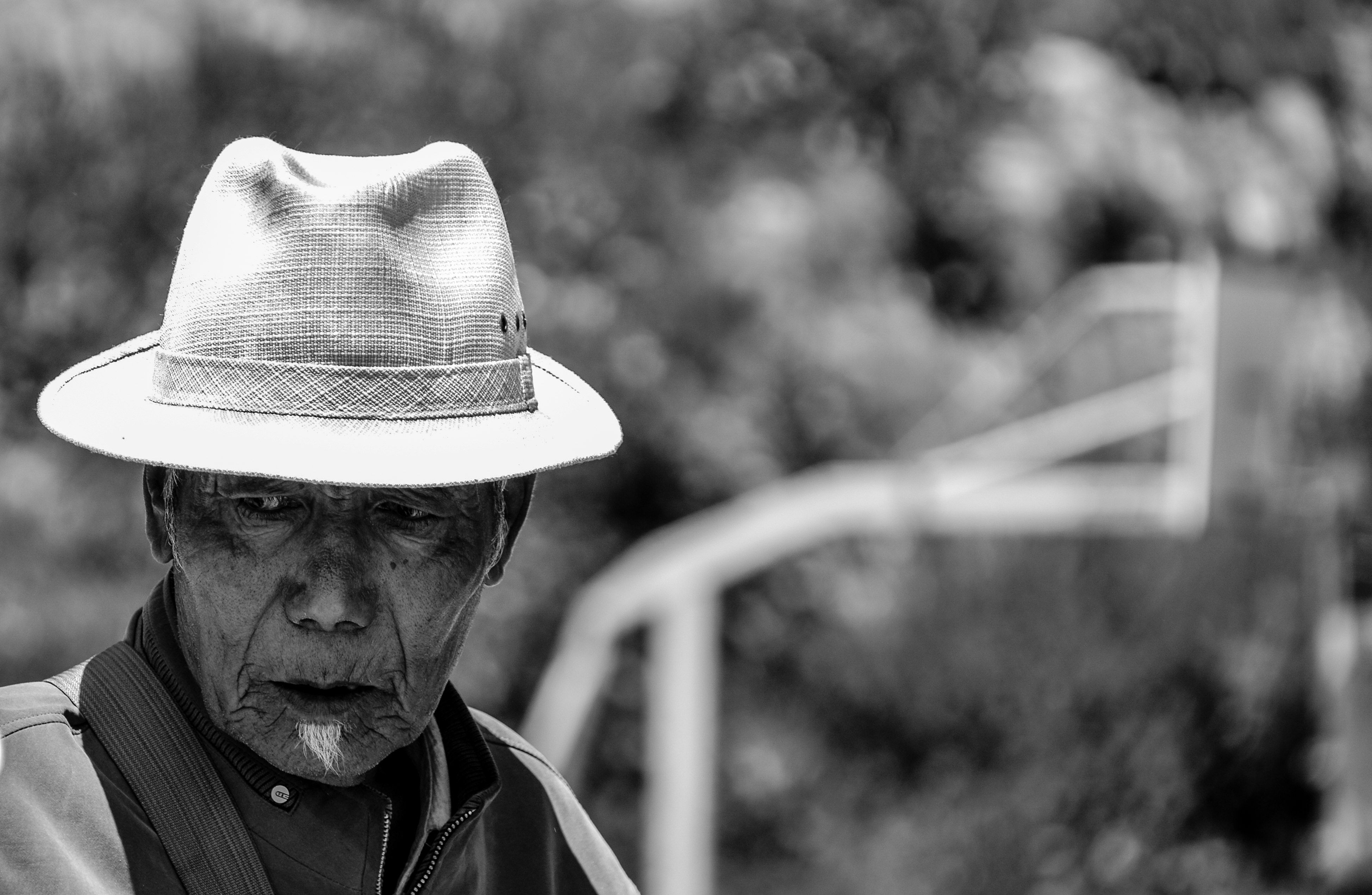 grayscale photo of man wearing hat